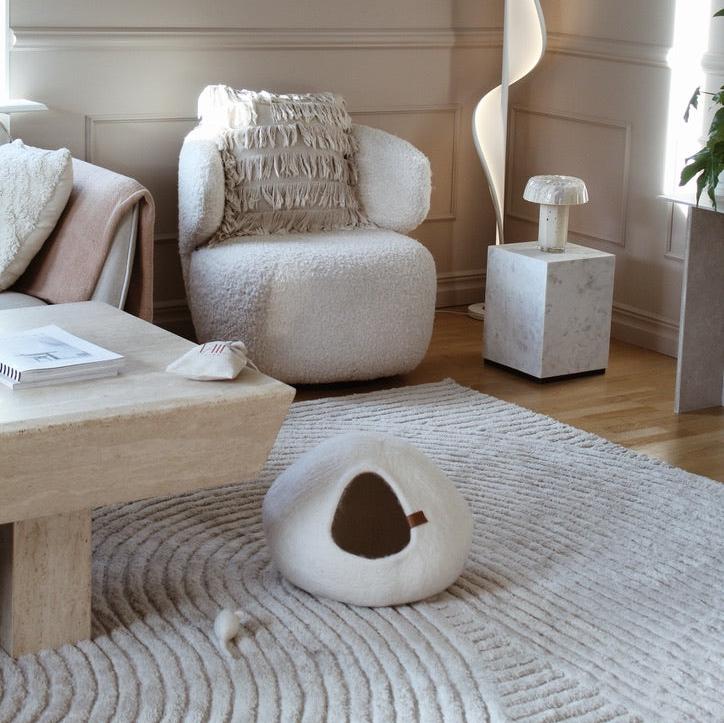 Image - cat bed in a white color on the floor in a stylish living room