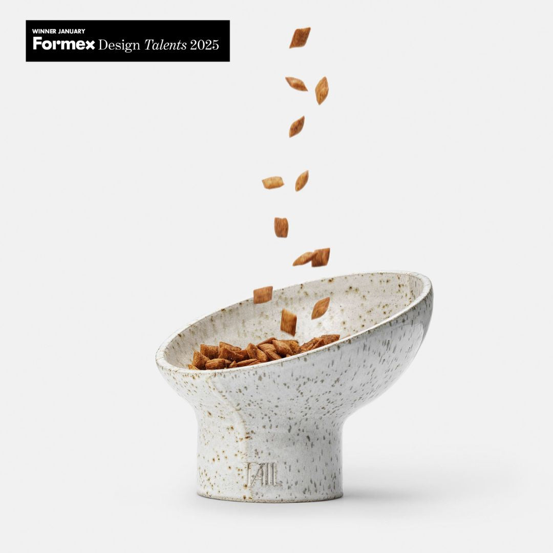 Image - white cat bowl from the side with food being dropped into it and formex winner logo