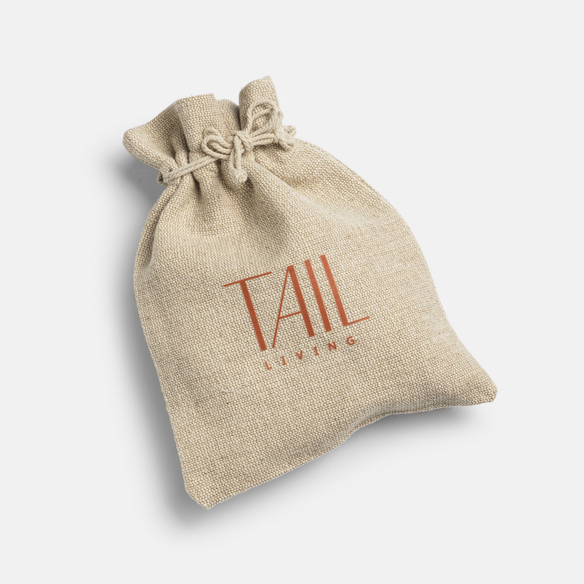 Image - beige jute bag for cat toys with tail living logo in a brown orange colour.